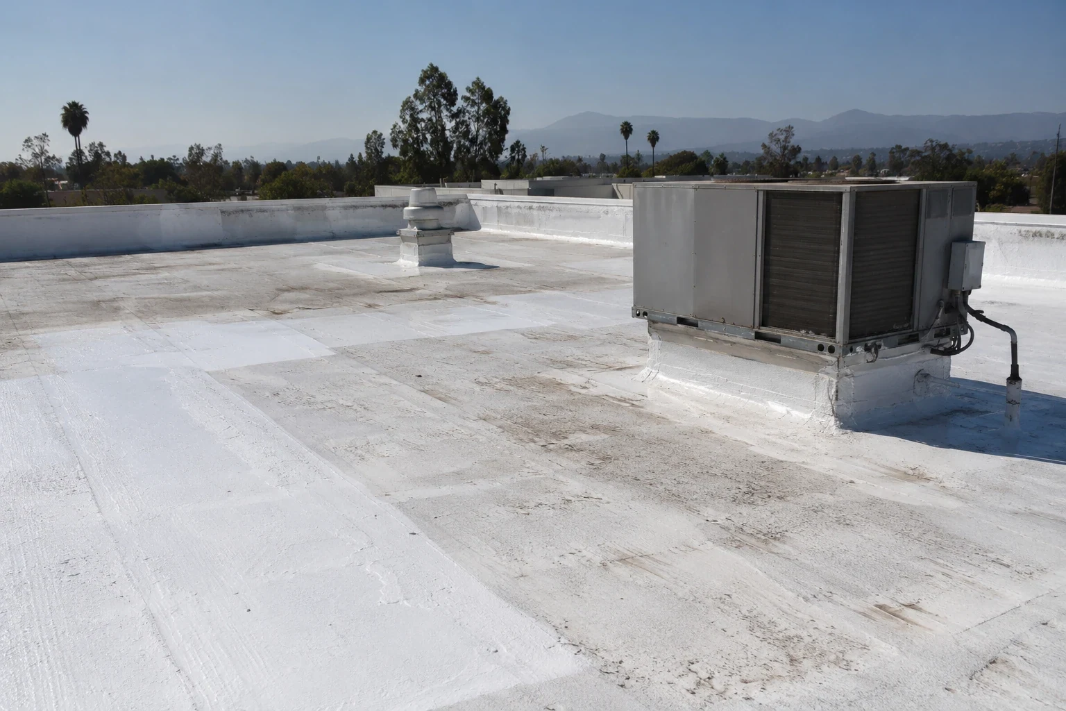 Roof coating restoration on a commercial roof